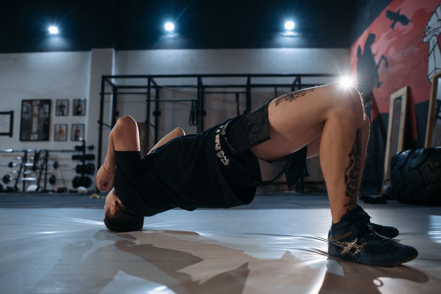 Man performing a glute bridge on the floor