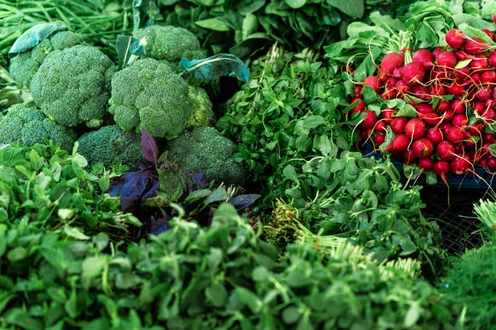 Broccoli, leafy greens and radishes at a market